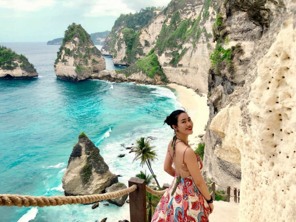 Tourists capturing photos at Diamond Beach in Nusa Penida